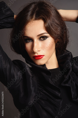 Vintage style portrait of young beautiful woman with red lipstick