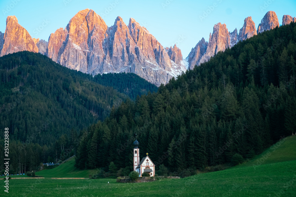 Amazing View of Famous alpine place of the world, Santa Maddalena village church with fantastic Dolomites mountains in background at sunset, Val di Funes valley, Trentino Alto Adige region, Italy