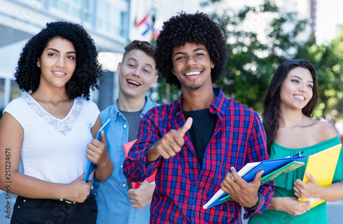 Successful african american hipster student with group of international students