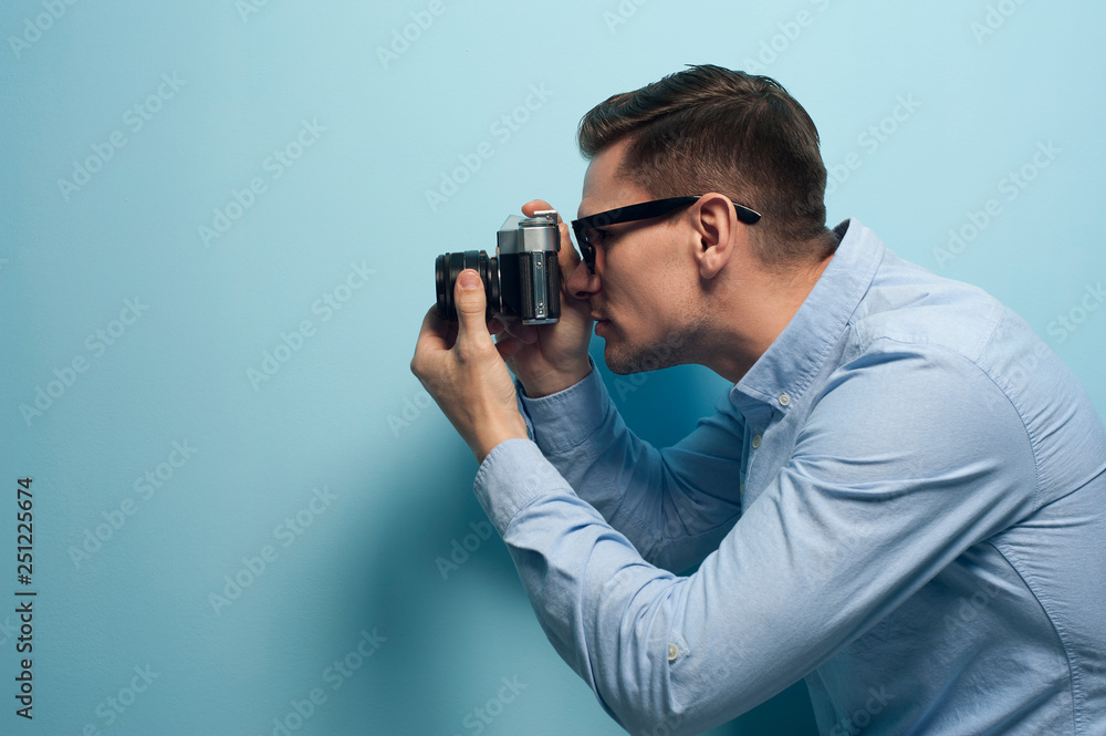 Young male photographer holding a new camera