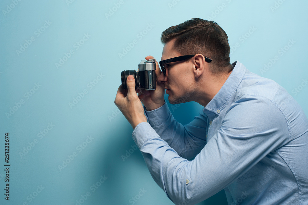 Young male photographer holding a new camera Young male photographer holding a new camera