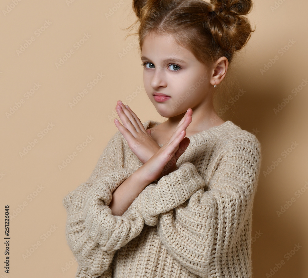 Portrait of serious, unhappy kid girl holding two arms crossed, gesturing no sign, looking away camera Portrait of serious, unhappy kid girl holding two arms crossed, gesturing no sign, looking away camera