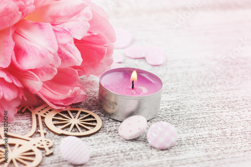 Fresh pink tulip flowers and candle