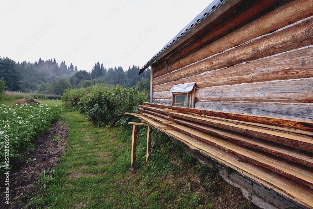 Front view of wooden house in russian village in sunny summer day Front view of wooden house in russian village in sunny summer day