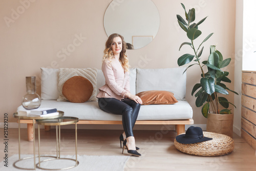 Bild auf Leinwand Girl in leather pants and high heels in room interior