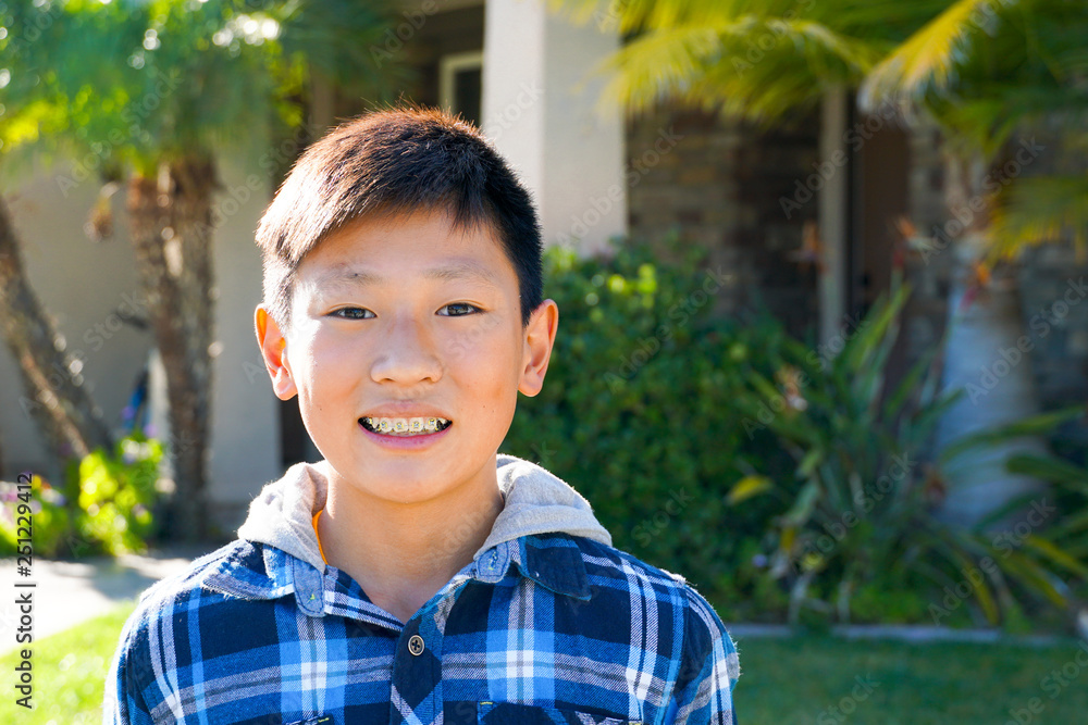 Portrait of young Asian boy with tooth braces. Young teen boy smiling and showing his orthodontic braces on his teeth. Portrait of young Asian boy with tooth braces. Young teen boy smiling and showing his orthodontic braces on his teeth.