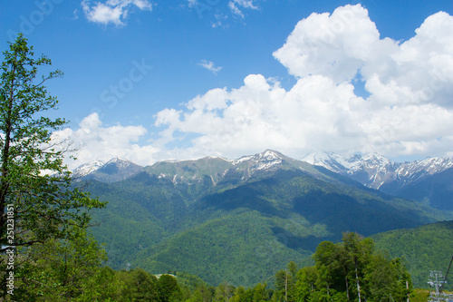 Beautiful mountain landscape and meadows on summer sunny day. Nice blue cloudy sky. green mountains and hills