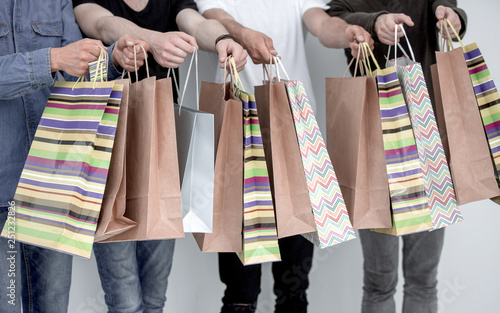 a group of people holds a gift bag.