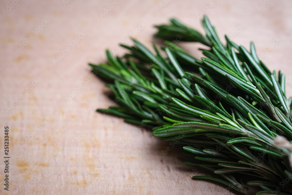 Fresh rosemary grass on a light board top view copy space Fresh rosemary grass on a light board top view copy space
