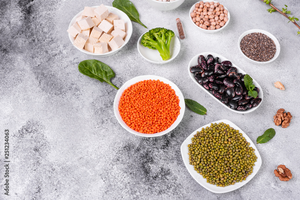 Superfoods on a gray background with copy space. Nuts, beans, greens and seeds. Healthy vegan food Superfoods on a gray background with copy space. Nuts, beans, greens and seeds. Healthy vegan food