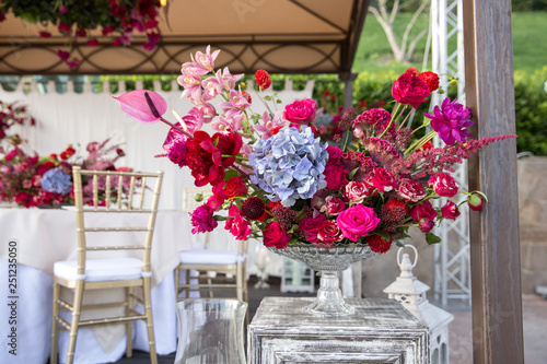 Flower arrangement of bright colors in a glass vase. Wedding floristry