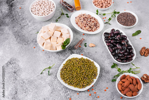 Superfoods on a gray background with copy space. Nuts, beans, greens and seeds. Healthy vegan food © chernikovatv