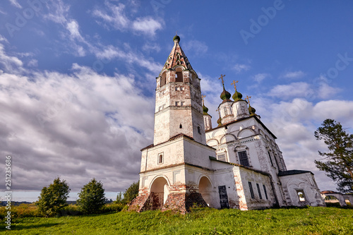 Old orthodox church at village. Summer view with floral meadow.