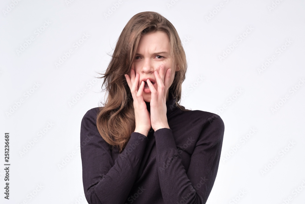 European pretty young woman scared ,afraid and anxious biting her finger nails European pretty young woman scared ,afraid and anxious biting her finger nails