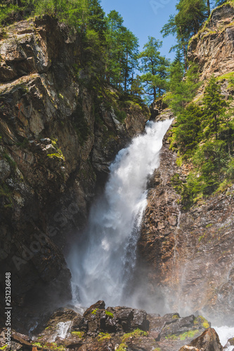 beautiful waterfall in a wood on the Italian Dolomites