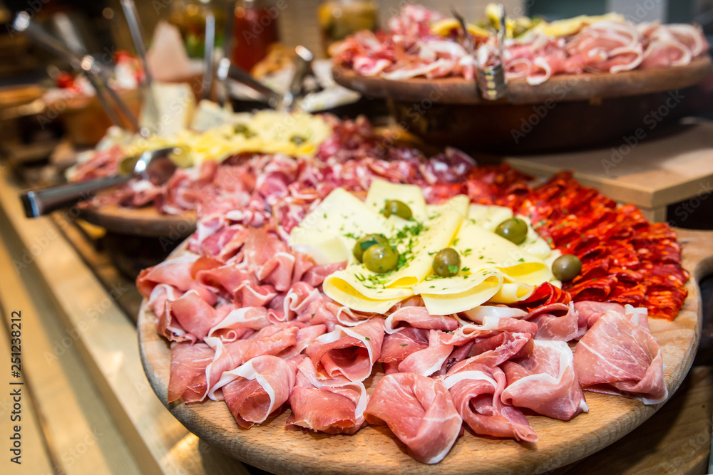 Appetizer. Wooden board with prosciutto, salami and cheese Appetizer. Wooden board with prosciutto, salami and cheese