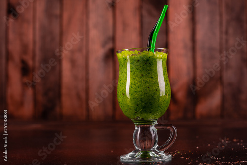 Ginger green apple smoothie on concrete background. It can be used as a background