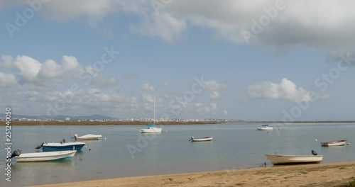 Timelapse cloudy seascape, in Ria Formosa wetlands natural park, shot in Faro beach whit the city in the background, Algarve. Portugal.