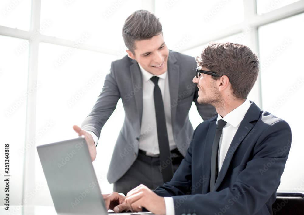 smiling colleagues looking at the laptop screen smiling colleagues looking at the laptop screen
