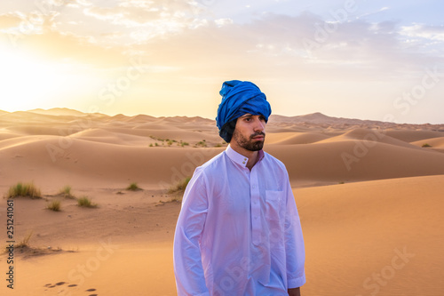 Berber man wearing traditional clothes in the Sahara Desert at dawn  Morocco