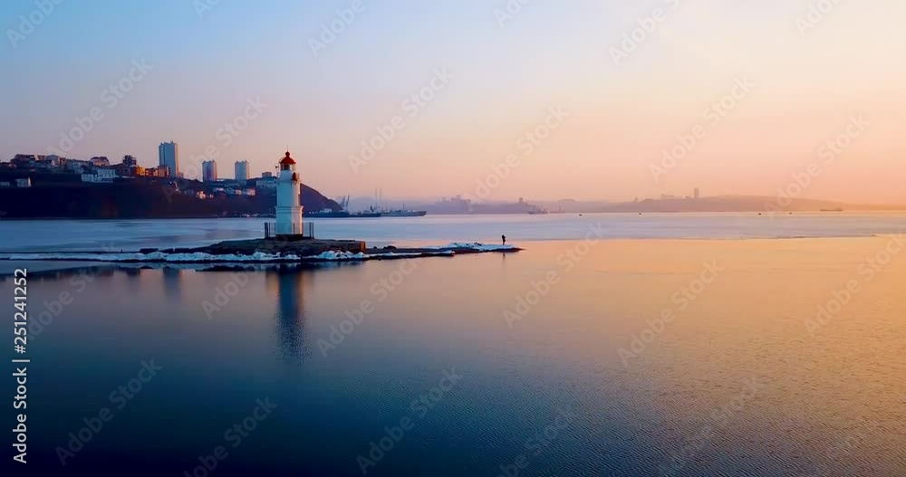 Top aerial panoramic view of Tokarev Lighthouse in Vladivostok. The lighthouse is located in the Peter the Great Bay of the Golden Horn. One of the oldest lighthouses of the Far East. Top aerial panoramic view of Tokarev Lighthouse in Vladivostok. The lighthouse is located in the Peter the Great Bay of the Golden Horn. One of the oldest lighthouses of the Far East.