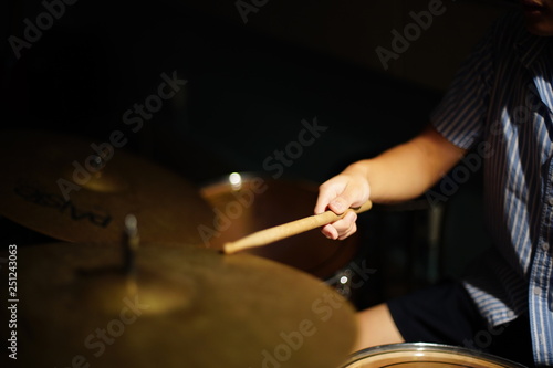 Student learn to play drum   Hand holding stick thumping the drum