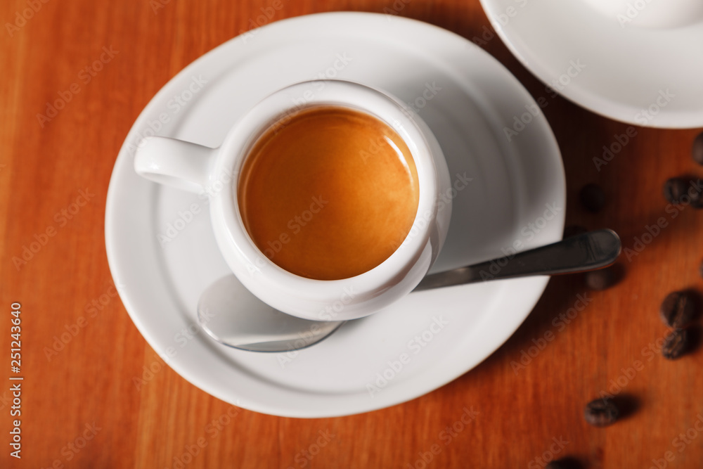 White coffee Cup with delicious foam, close-up top view on wooden background. Concept of coffee break and serving coffee White coffee Cup with delicious foam, close-up top view on wooden background. Concept of coffee break and serving coffee