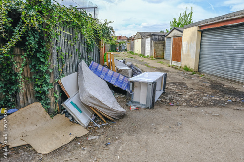 Bed, divan, fridge and freezer fly tipped in an alleyway.