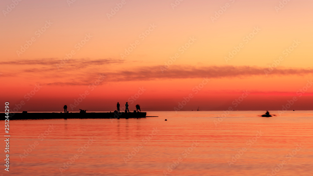 Fishermen catch fish at sunrise