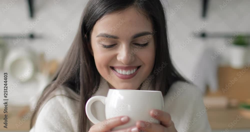 Young girl enjoying her morning coffee in the kitchen Young girl enjoying her morning coffee in the kitchen