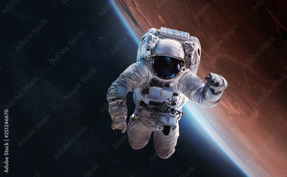 Astronaut float in outer space over of the Mars on the