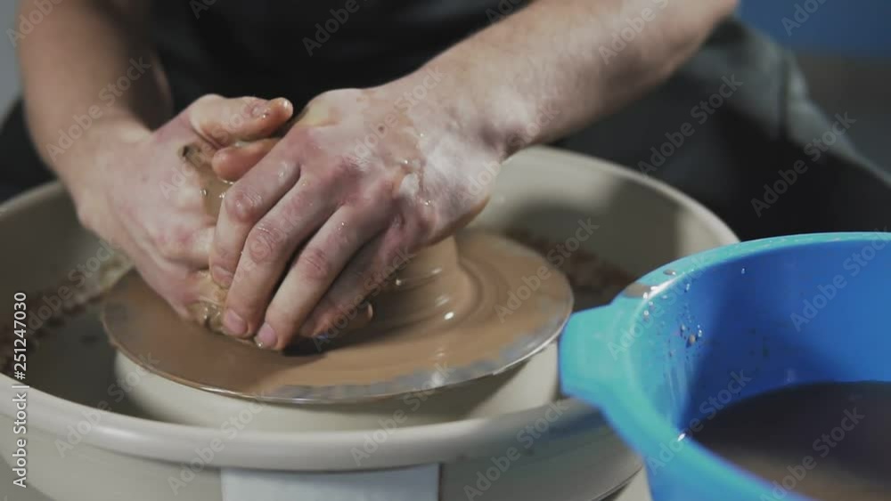 Creating vase of clay. Sculptor in workshop makes jug out of clay closeup. Twisted potter's wheel. Potter's work close-up. Man hands making clay jug. Handmade. Craft. Creating vase of clay. Sculptor in workshop makes jug out of clay closeup. Twisted potter's wheel. Potter's work close-up. Man hands making clay jug. Handmade. Craft.