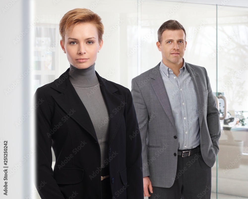 Portrait of business people standing at office Portrait of business people standing at office