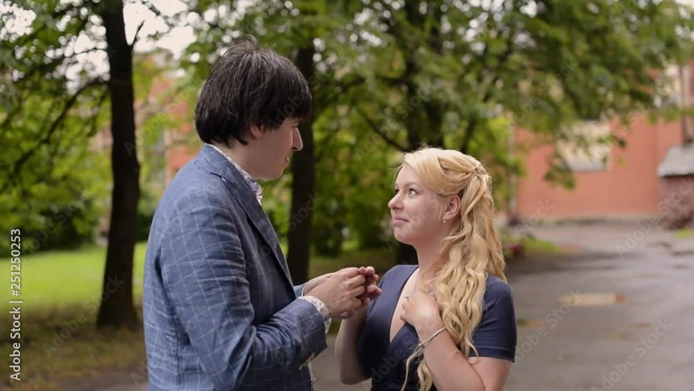 Young lovely couple walking in summer. Romantic dating or lovestory. Man making proposal for his girl. Woman becomes bride with engagement ring Young lovely couple walking in summer. Romantic dating or lovestory. Man making proposal for his girl. Woman becomes bride with engagement ring