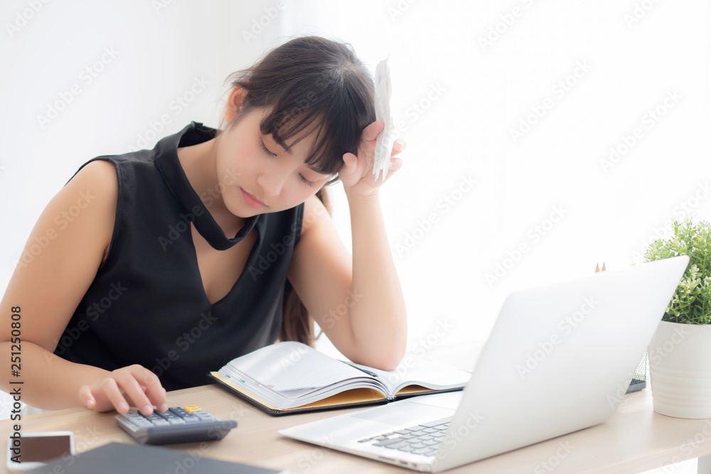 Beautiful young asian woman calculating expenses household and writing notebook on desk, girl checking bill and stress and note, female worry debt and tax, finance and business concept. Beautiful young asian woman calculating expenses household and writing notebook on desk, girl checking bill and stress and note, female worry debt and tax, finance and business concept.