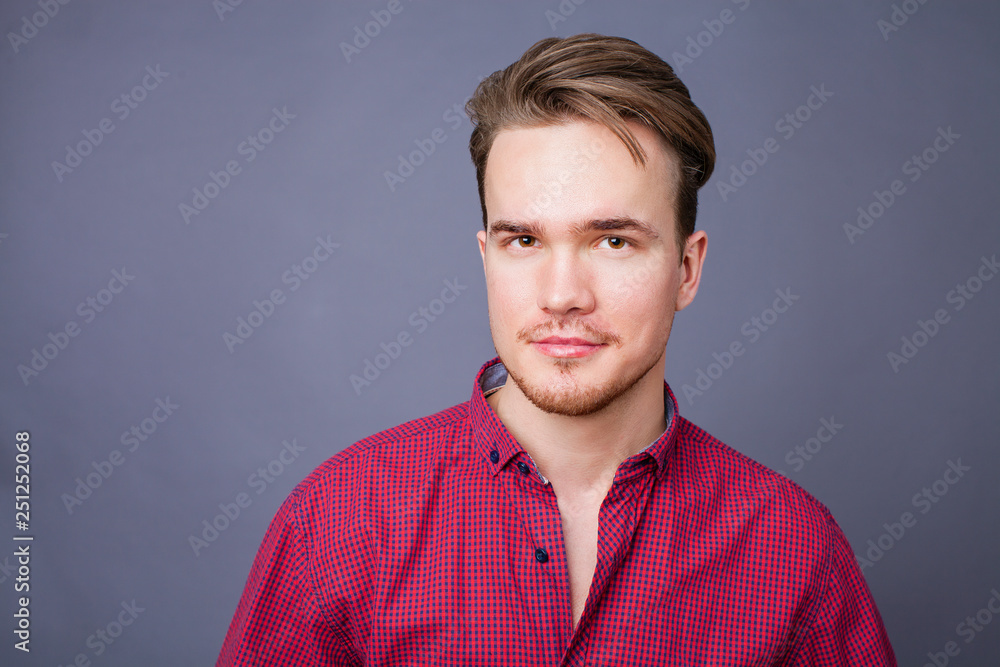 Obraz premium Studio portrait of young man on a dark background