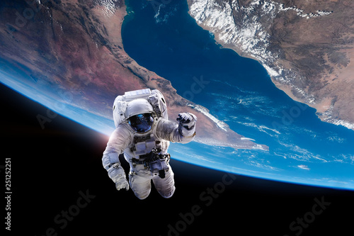 Fototapeta Naklejka Na Ścianę i Meble -  Astronaut in outer space on orbit of the Earth. Elements of this image furnished by NASA