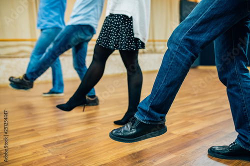 Dancing people in a row in the dance hall salon. Dancing school activity