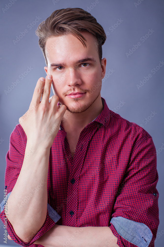 Studio portrait of young man on a dark background Studio portrait of young man on a dark background