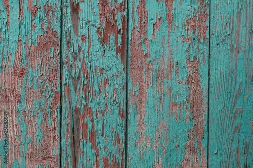 cracked vertical wooden panel with peeling green paint, textured surface background © photoguns