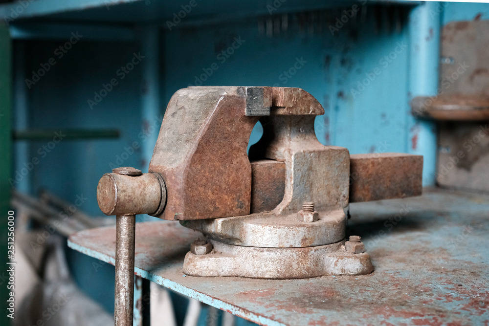bench vise tool on metal workbench, vice grip on metallic table, professional clamp construction in workshop bench vise tool on metal workbench, vice grip on metallic table, professional clamp construction in workshop