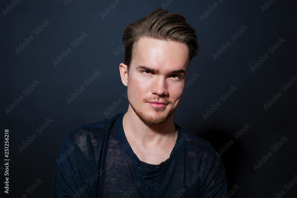 Studio portrait of a young man on a dark background