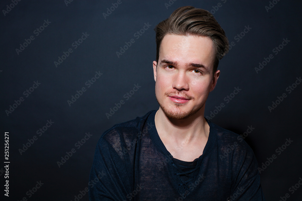 Studio portrait of young man on a dark background Studio portrait of young man on a dark background
