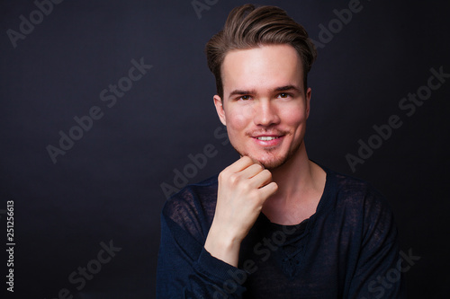 Studio portrait of young man on a dark background