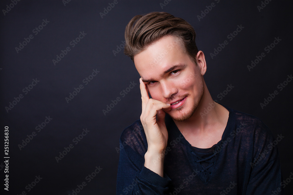 Studio portrait of young man on a dark background Studio portrait of young man on a dark background