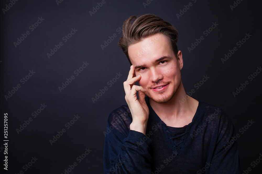 Studio portrait of young man on a dark background