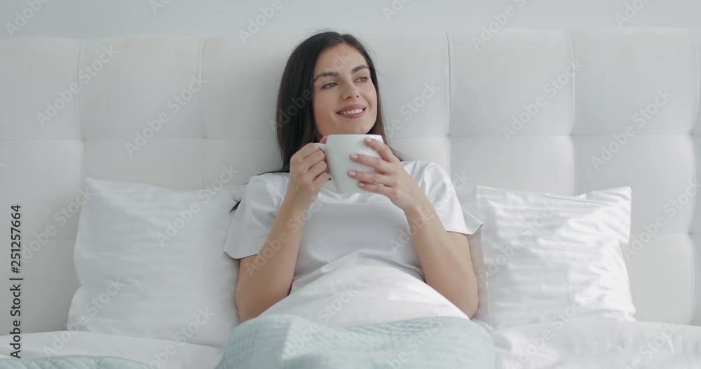 Good morning! Girl having morning coffee in bed Good morning! Girl having morning coffee in bed