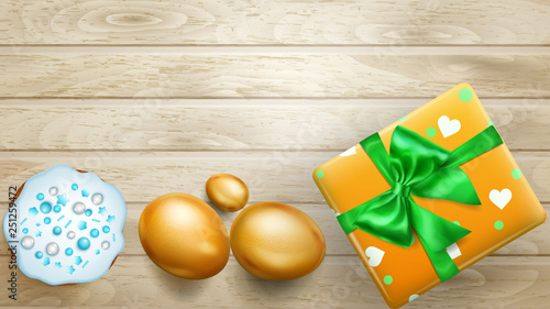 Realistic golden Easter eggs, tasty cake and beautiful gift box with bow on wooden planks