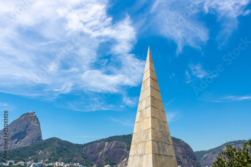 beautiful view of the monument to Estacio de Sá, with background to the mountain of Pão de Açucar in Rio de Janeiro, Brazil, on a beautiful and relaxing day of sun, with blue sky and white clouds photo