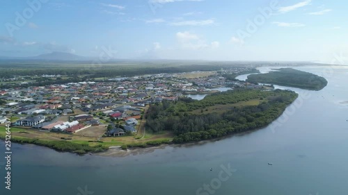 Aerial descend over river and rural coastal town in New South Wales, Australia photo